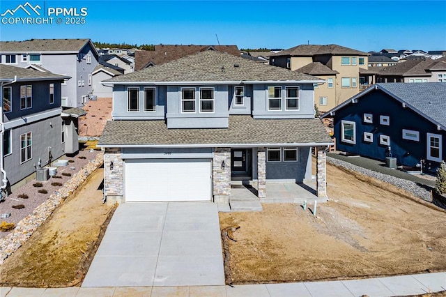 view of front of property featuring a garage, a residential view, driveway, and a shingled roof