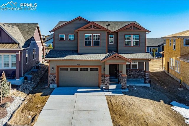 craftsman house with stone siding, concrete driveway, a shingled roof, and an attached garage