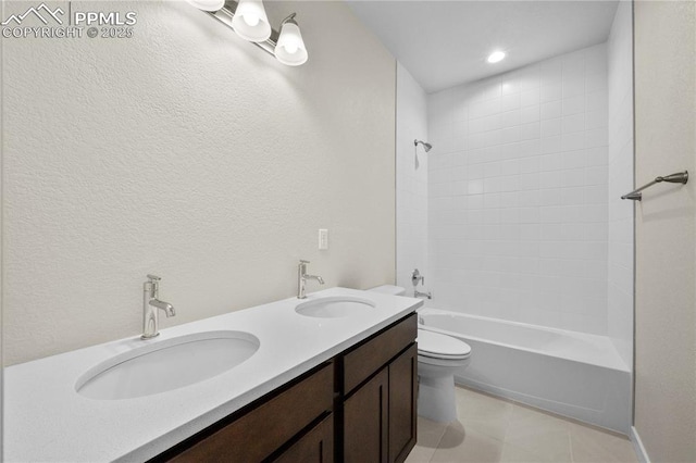 bathroom featuring shower / bathing tub combination, tile patterned flooring, a sink, and toilet