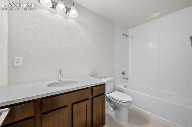 full bath featuring a textured wall, bathtub / shower combination, toilet, vanity, and tile patterned floors