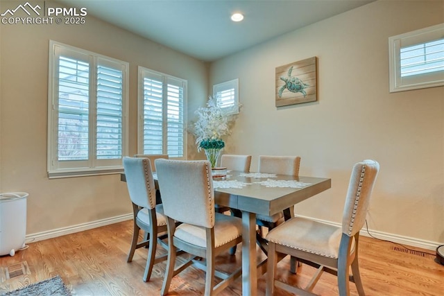 dining space with recessed lighting, wood finished floors, and baseboards