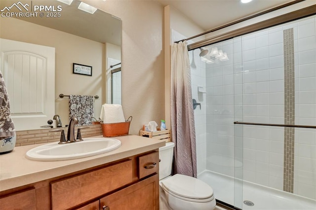 full bath with toilet, a shower stall, and vanity