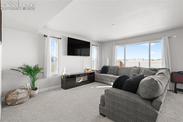 living room featuring carpet, a textured ceiling, and baseboards