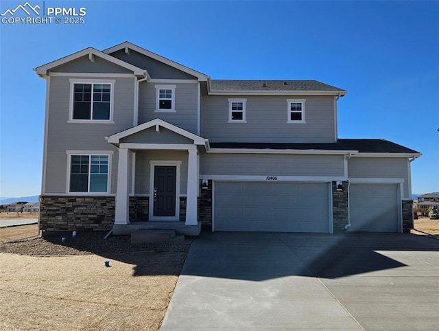 craftsman inspired home featuring stone siding and driveway