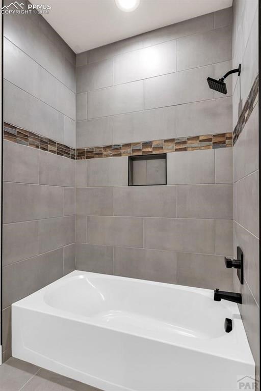 bathroom featuring tub / shower combination and tile patterned flooring