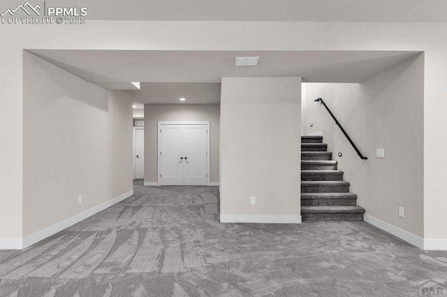 finished below grade area with stairway, carpet, baseboards, and recessed lighting