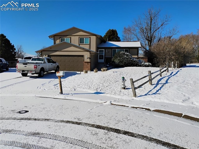 split level home with driveway and fence