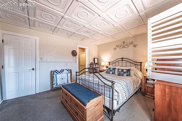 bedroom featuring an ornate ceiling and dark carpet