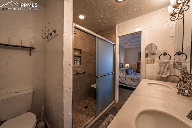 full bathroom featuring a stall shower, connected bathroom, and a sink