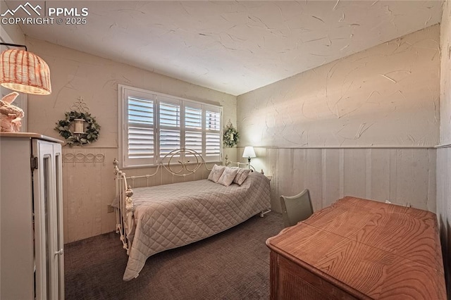 bedroom featuring carpet floors and a wainscoted wall