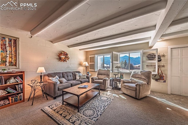 living room with beamed ceiling and carpet