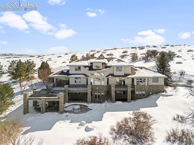 view of front of house with a garage and stone siding