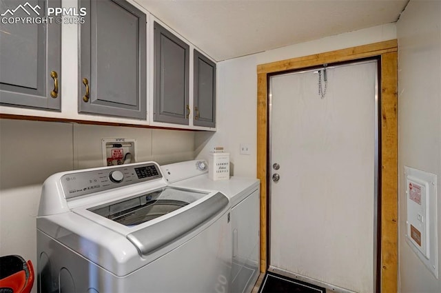 clothes washing area with cabinet space and separate washer and dryer