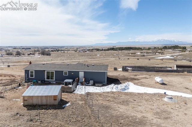 exterior space with a mountain view and view of desert