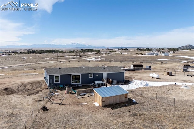 birds eye view of property with a desert view and a mountain view