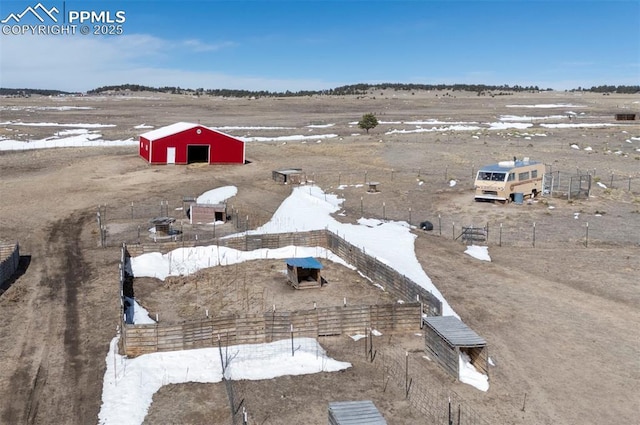 snowy aerial view featuring a rural view