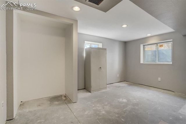 unfurnished bedroom featuring concrete floors, visible vents, and recessed lighting