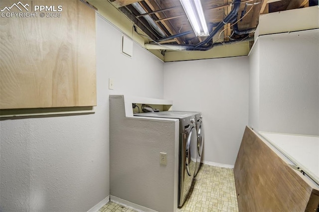 washroom with laundry area, washer and clothes dryer, baseboards, and tile patterned floors