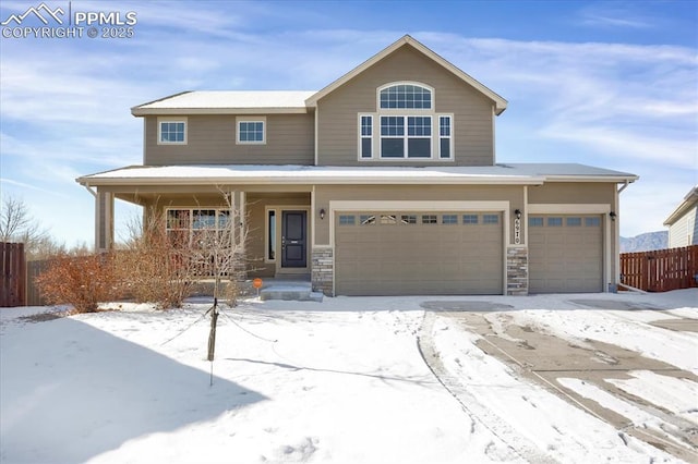 view of front of property with a porch, stone siding, and fence