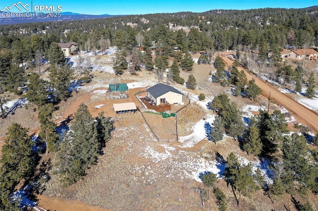 birds eye view of property with a wooded view