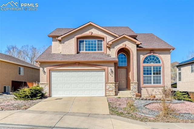 view of front of property with a garage, stone siding, driveway, and stucco siding