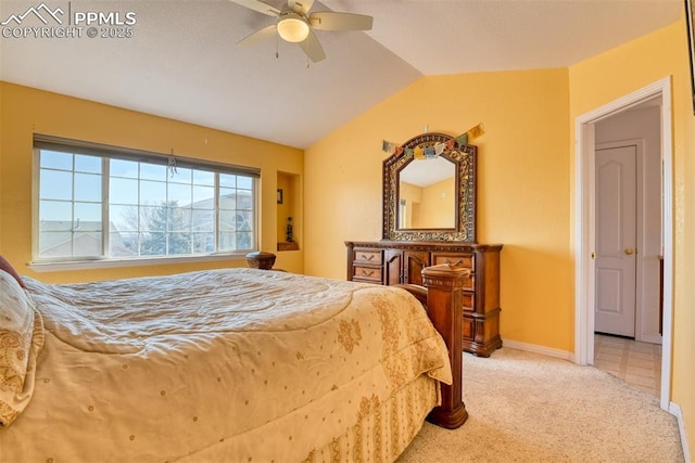 carpeted bedroom featuring lofted ceiling, baseboards, and a ceiling fan