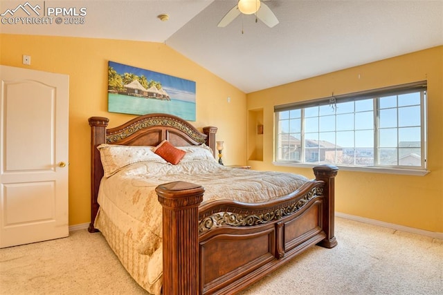 carpeted bedroom featuring vaulted ceiling, baseboards, and ceiling fan