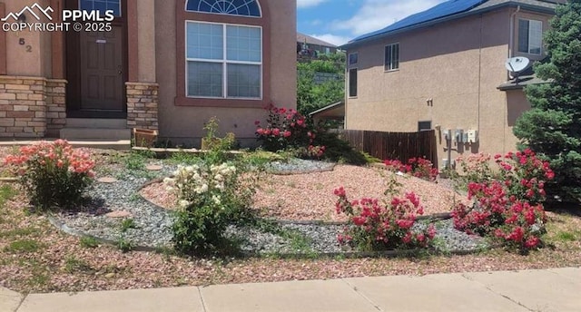 view of side of property with stone siding and stucco siding