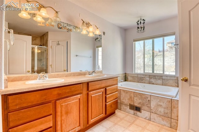 bathroom featuring a garden tub, double vanity, a stall shower, and a sink