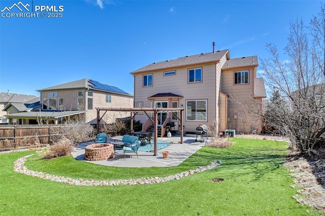 rear view of house featuring a fire pit, a yard, a patio area, and fence