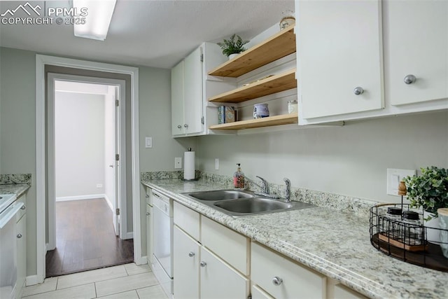 9995 E Harvard Ave Unit 155, Denver, CO 80231 - kitchen with baseboards, white cabinets, white dishwasher, open shelves, and a sink
