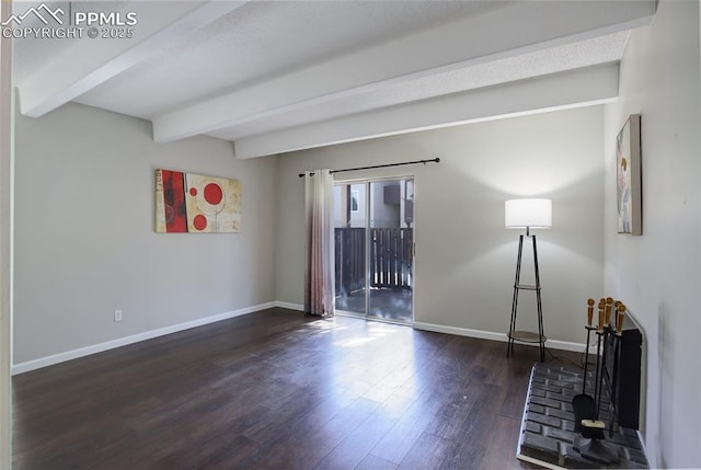 9995 E Harvard Ave Unit 155, Denver, CO 80231 - spare room with wood finished floors, beam ceiling, and baseboards