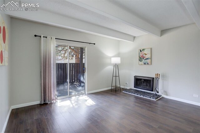 9995 E Harvard Ave Unit 155, Denver, CO 80231 - unfurnished living room with a fireplace, baseboards, beam ceiling, and wood finished floors