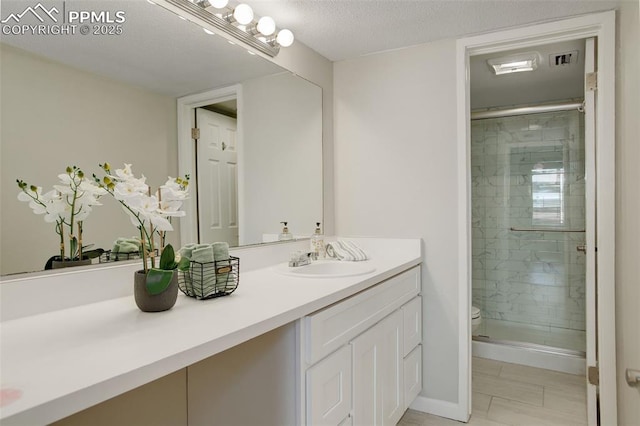 9995 E Harvard Ave Unit 155, Denver, CO 80231 - full bathroom featuring a textured ceiling, vanity, a shower stall, and toilet