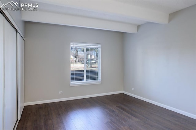 9995 E Harvard Ave Unit 155, Denver, CO 80231 - unfurnished bedroom featuring dark wood finished floors, a closet, beamed ceiling, and baseboards