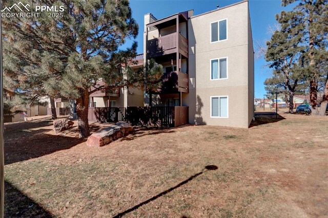 9995 E Harvard Ave Unit 155, Denver, CO 80231 - back of property with a yard and stucco siding