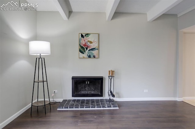 9995 E Harvard Ave Unit 155, Denver, CO 80231 - living room featuring baseboards, a fireplace with raised hearth, beamed ceiling, and wood finished floors