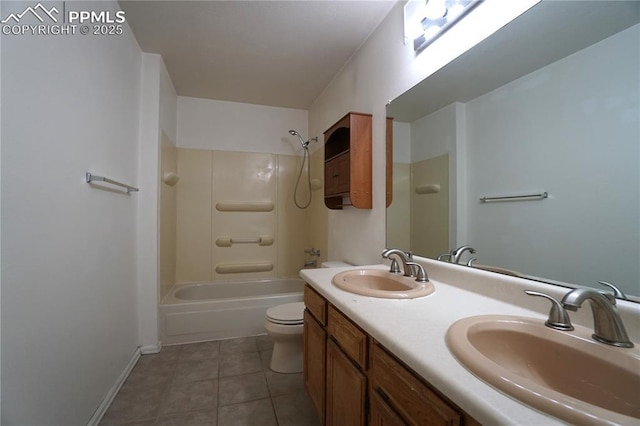 bathroom featuring toilet, double vanity, a sink, and tile patterned floors