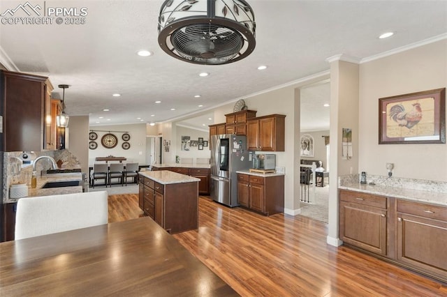 kitchen featuring ornamental molding, a sink, light wood-style flooring, and smart refrigerator