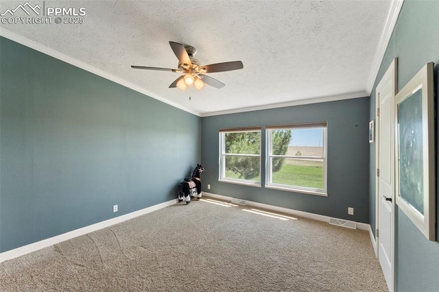 empty room featuring a textured ceiling, ornamental molding, carpet, and baseboards