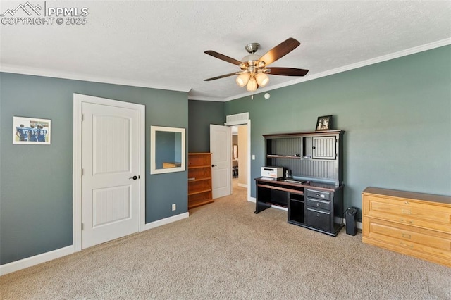 carpeted office featuring ornamental molding, a textured ceiling, baseboards, and a ceiling fan