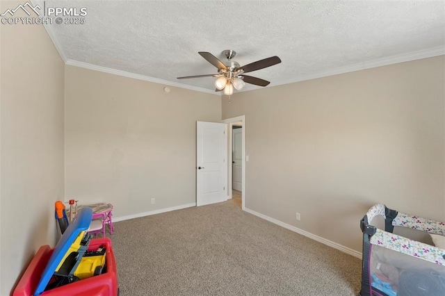 rec room with carpet floors, crown molding, a textured ceiling, and baseboards