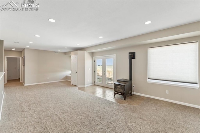 unfurnished living room with french doors, carpet flooring, and recessed lighting