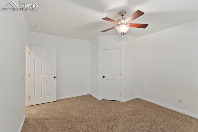 unfurnished room with carpet, baseboards, and a ceiling fan