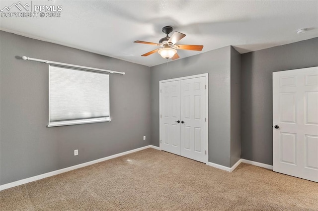 unfurnished bedroom with a ceiling fan, carpet, baseboards, and a closet