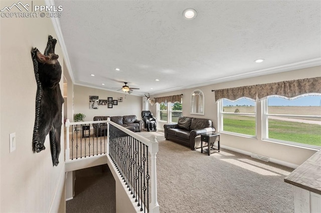 interior space featuring ornamental molding, carpet, a textured ceiling, and recessed lighting