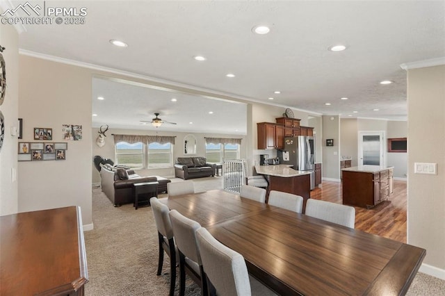 dining space with ornamental molding, recessed lighting, and baseboards