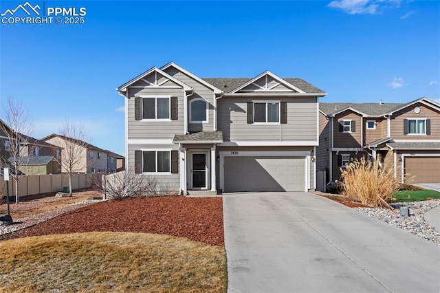 view of front of home featuring a garage, a residential view, fence, and concrete driveway