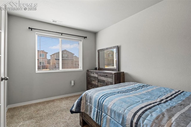 carpeted bedroom with visible vents and baseboards