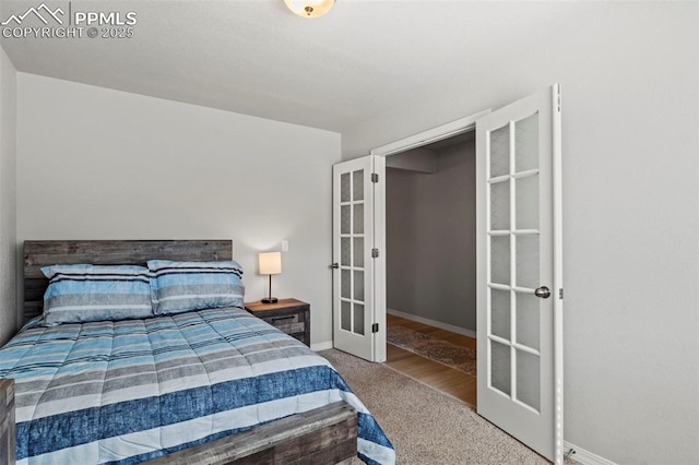 bedroom with carpet, french doors, and baseboards